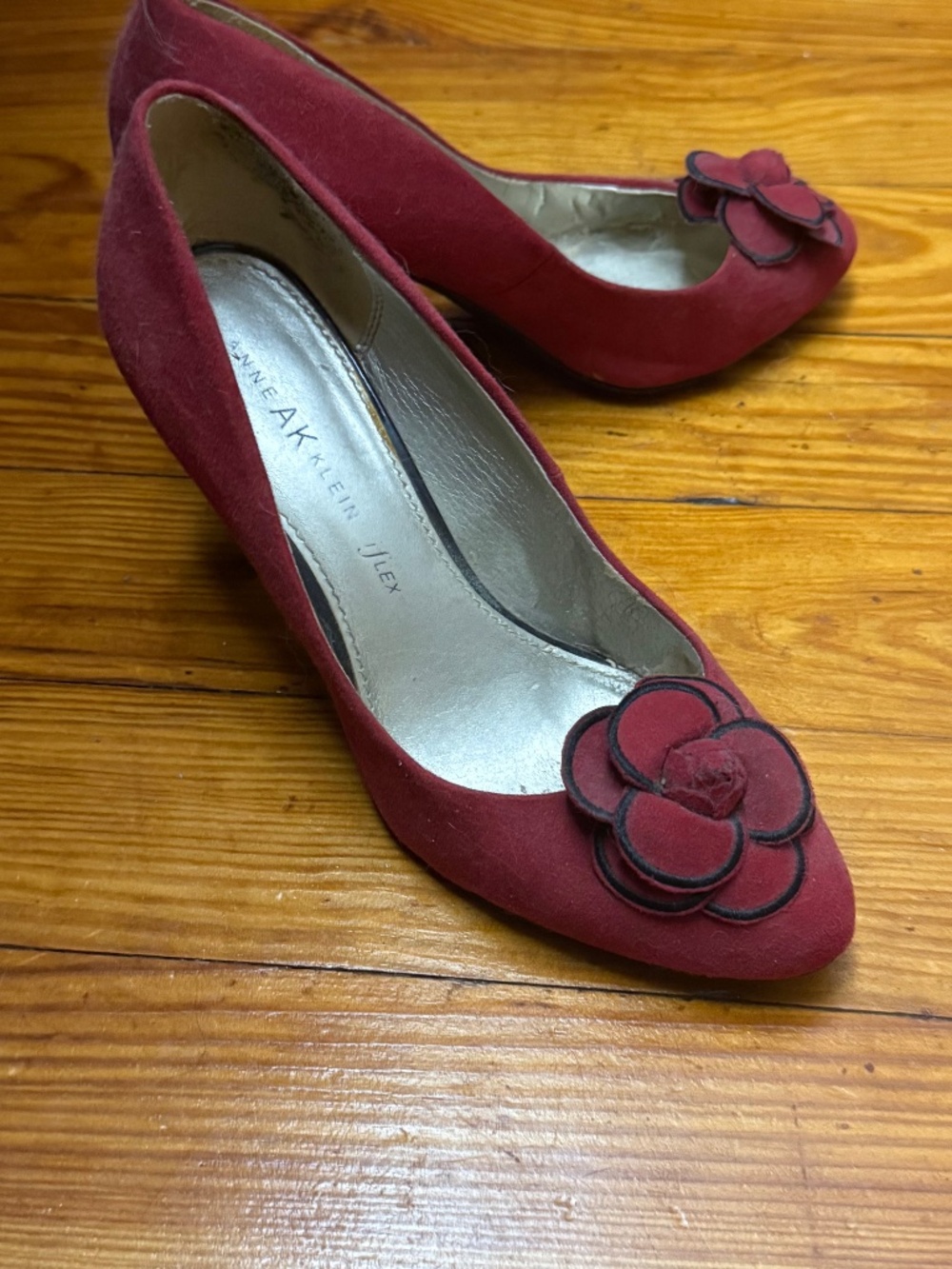 Red Anne Klein heels with rosettes